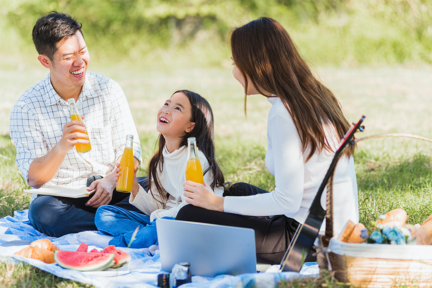 Family having a picnic wearing white clothes to help ward off mosquitoes and prevent dengue.