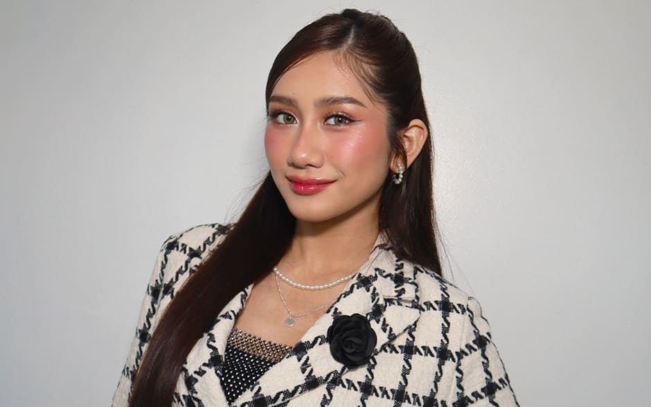 BINI Sheena posing confidently in a stylish checkered cropped blazer paired with a red skirt.